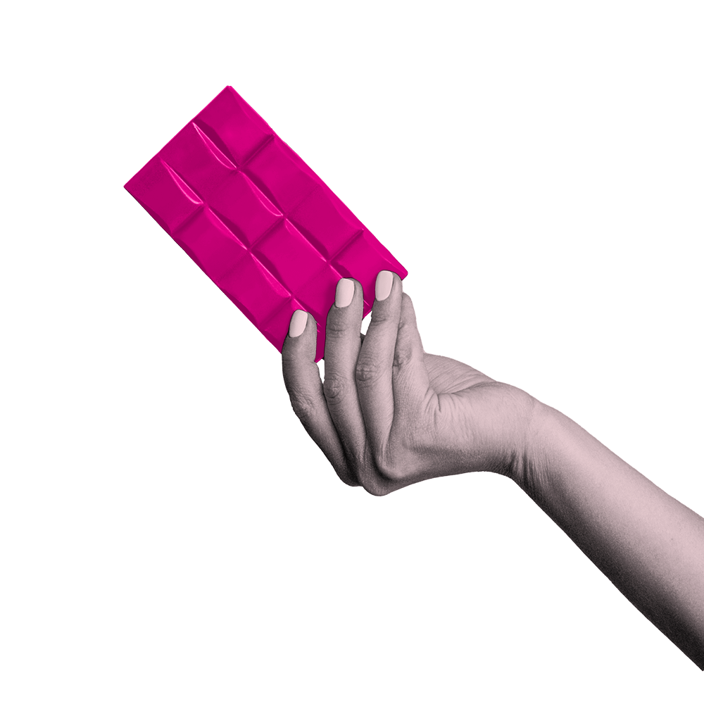 A hand holding a pink bar of chocolate